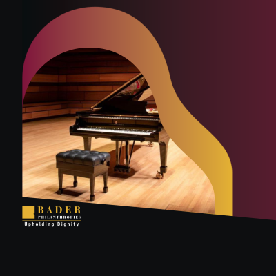 A piano sits on stage, ready to be played