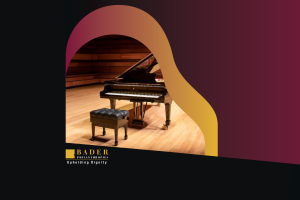 A piano sits on stage, ready to be played